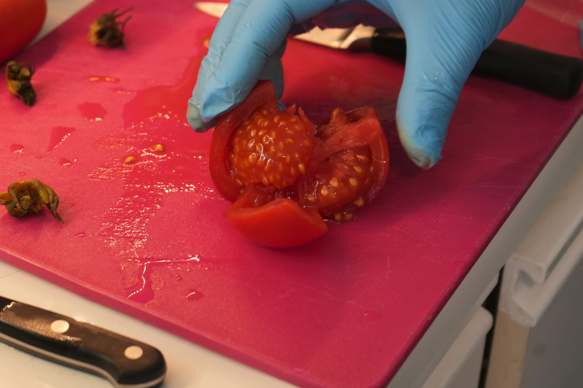 Sliced tomato exposing seeds and pulp.